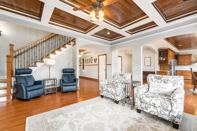 living area featuring ornamental molding, coffered ceiling, wood ceiling, and light hardwood / wood-style floors