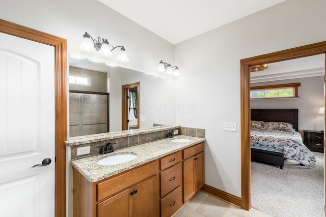 bathroom with vanity, tile patterned floors, and a shower with door