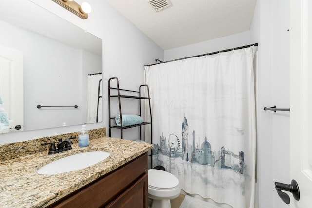 bathroom featuring vanity, a textured ceiling, toilet, and a shower with shower curtain