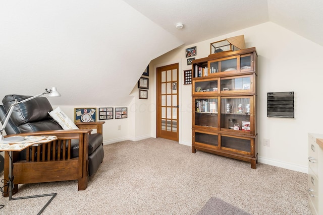 living area featuring vaulted ceiling and light carpet