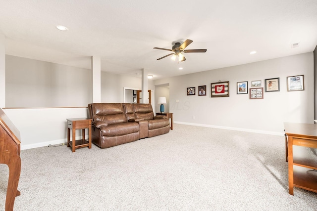 carpeted living room with ceiling fan