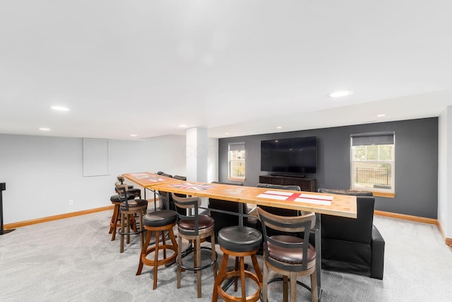 bar featuring light carpet and butcher block countertops