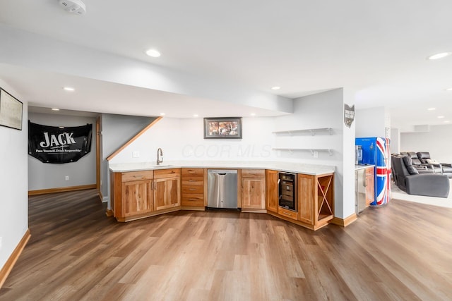 bar featuring wine cooler, sink, and light hardwood / wood-style flooring