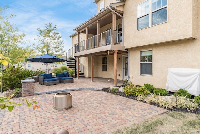 rear view of house with a patio and outdoor lounge area