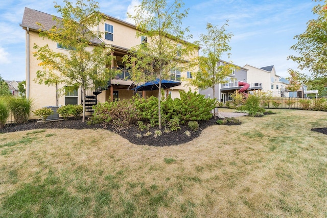 rear view of property with a yard