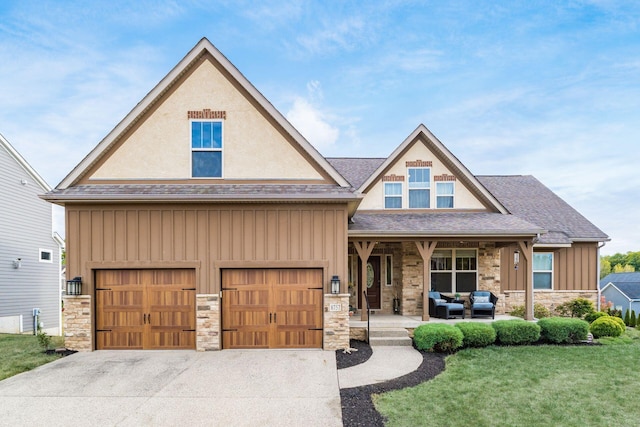 craftsman-style home featuring covered porch and a front lawn