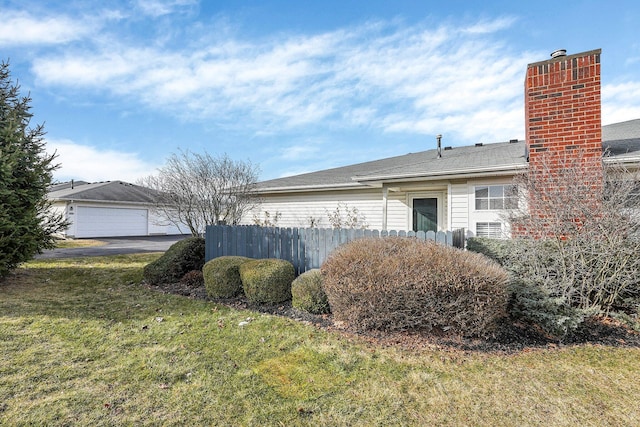 view of side of home with a yard