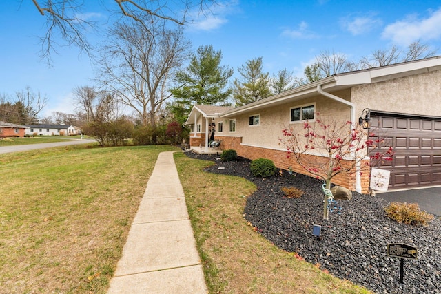 view of home's exterior featuring a lawn and a garage