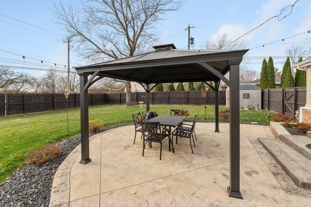 view of patio / terrace featuring a gazebo and a storage shed