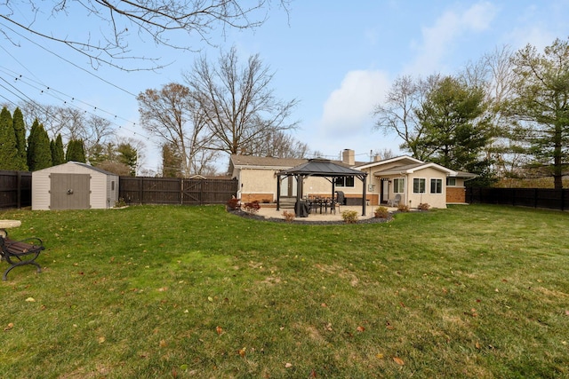 rear view of house with a gazebo, a storage unit, a patio area, and a lawn