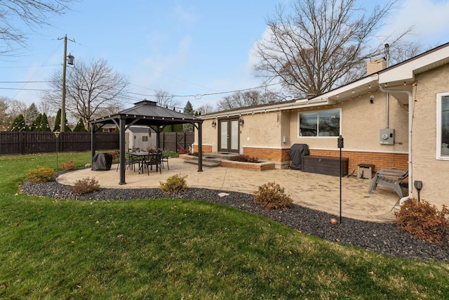 view of yard featuring a gazebo, a patio, and french doors