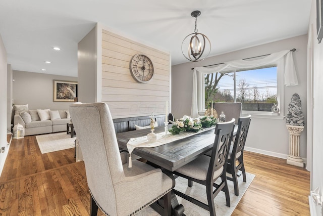 dining area with a chandelier and wood-type flooring