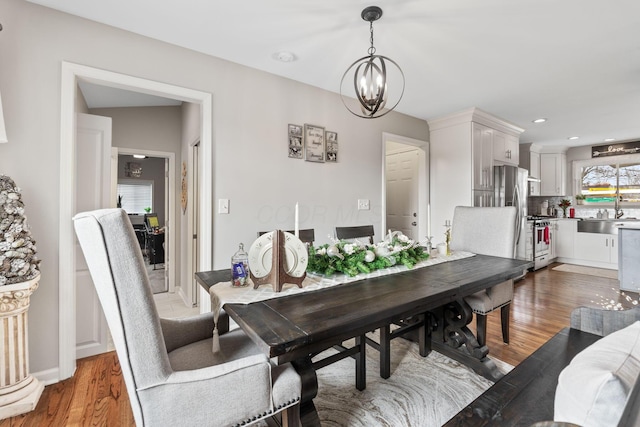 dining room with a chandelier and hardwood / wood-style flooring