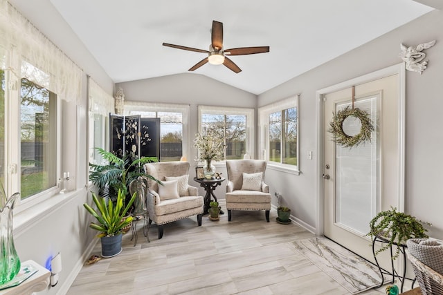 sunroom / solarium with a wealth of natural light, lofted ceiling, and ceiling fan