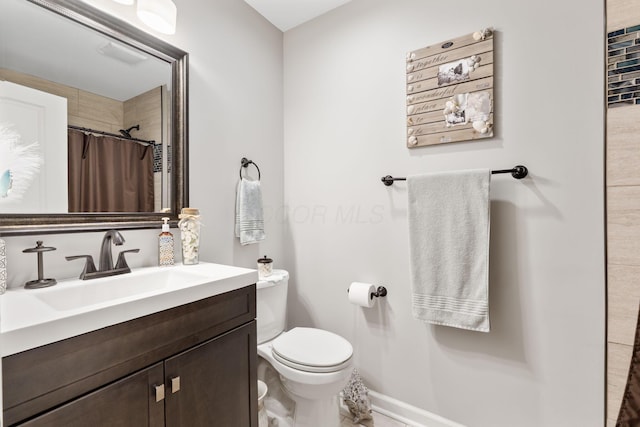 bathroom with vanity, toilet, and walk in shower