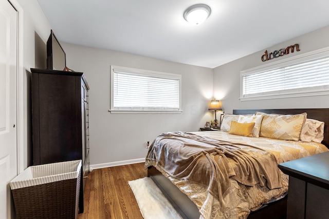 bedroom with dark hardwood / wood-style floors