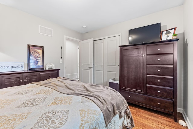 bedroom featuring light hardwood / wood-style flooring and a closet