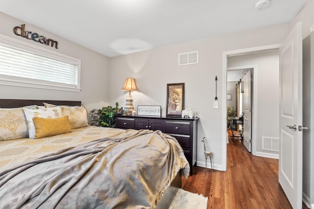 bedroom with dark wood-type flooring