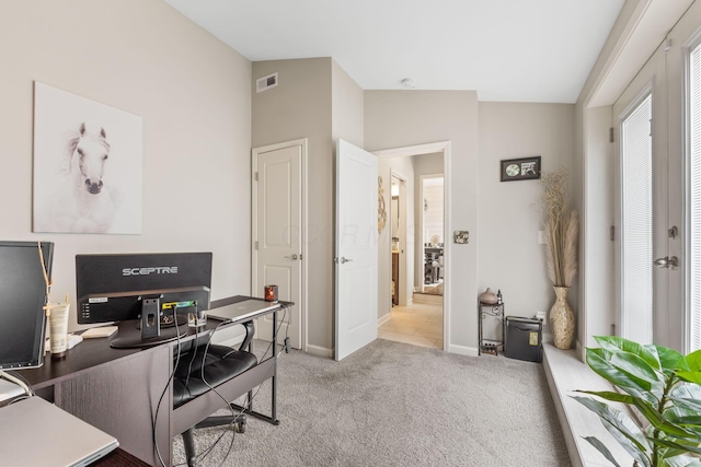 carpeted home office with lofted ceiling