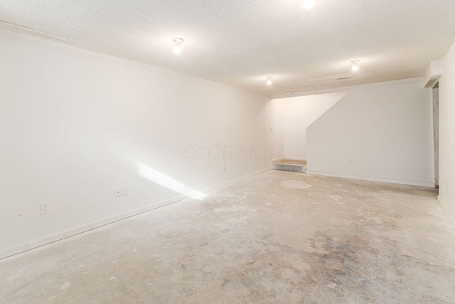 basement featuring a textured ceiling