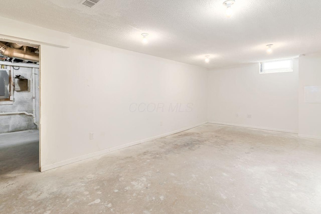 basement featuring a textured ceiling