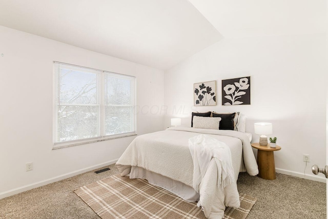 bedroom featuring lofted ceiling and carpet