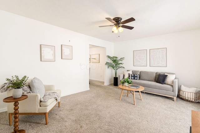 carpeted living room featuring ceiling fan