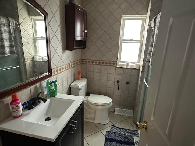 bathroom featuring tile walls, tile patterned floors, vanity, and toilet