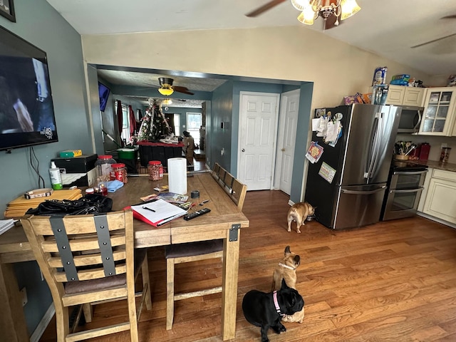 dining space featuring lofted ceiling and hardwood / wood-style flooring