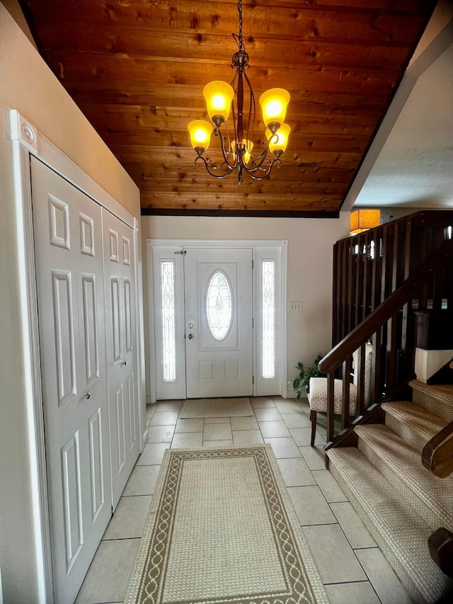 entrance foyer featuring an inviting chandelier, vaulted ceiling, light tile patterned floors, and wooden ceiling