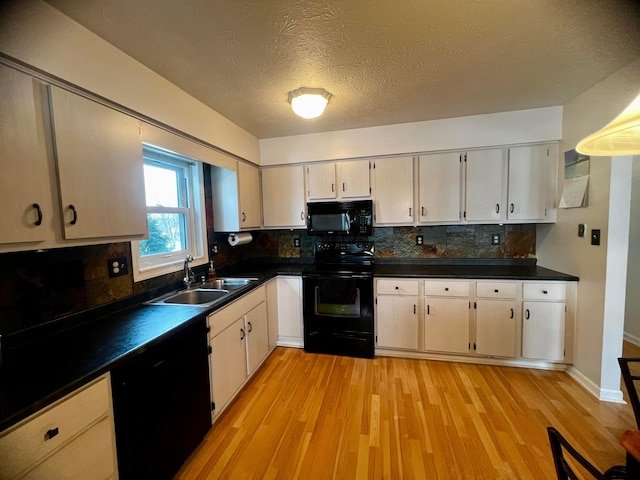 kitchen with black appliances, decorative backsplash, a textured ceiling, light hardwood / wood-style flooring, and sink