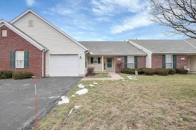 ranch-style home with a garage, covered porch, and a front lawn