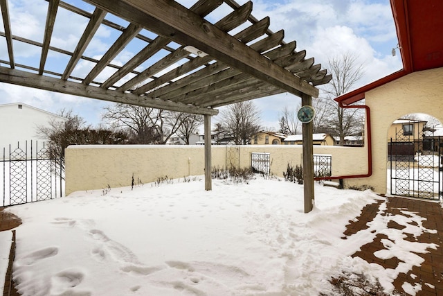 snowy yard with a pergola