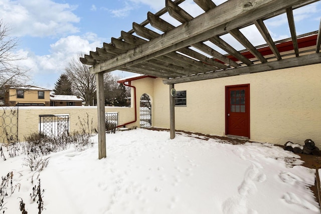 snow covered patio featuring a pergola