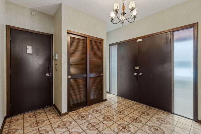 foyer featuring a chandelier