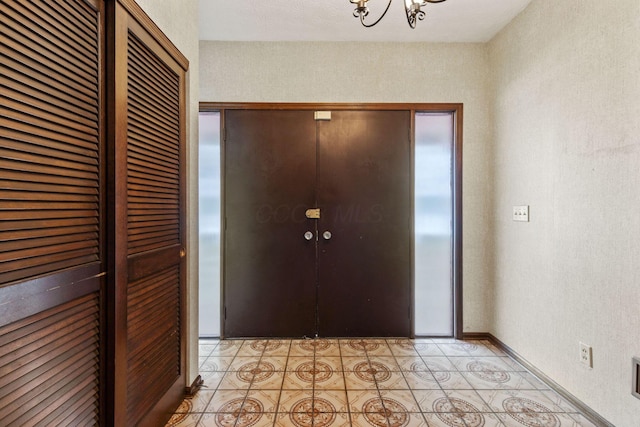 foyer featuring a chandelier