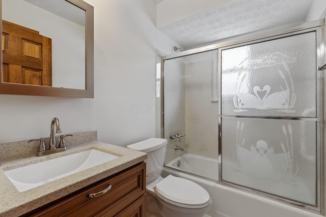 full bathroom with a textured ceiling, shower / bath combination with glass door, vanity, and toilet