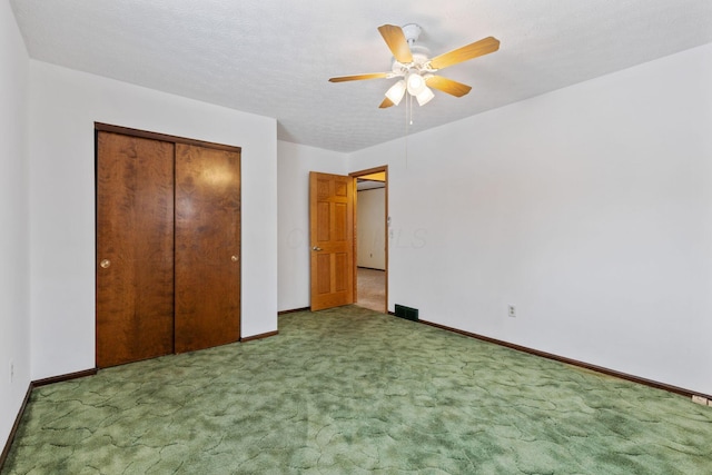 unfurnished bedroom with ceiling fan, a closet, carpet floors, and a textured ceiling