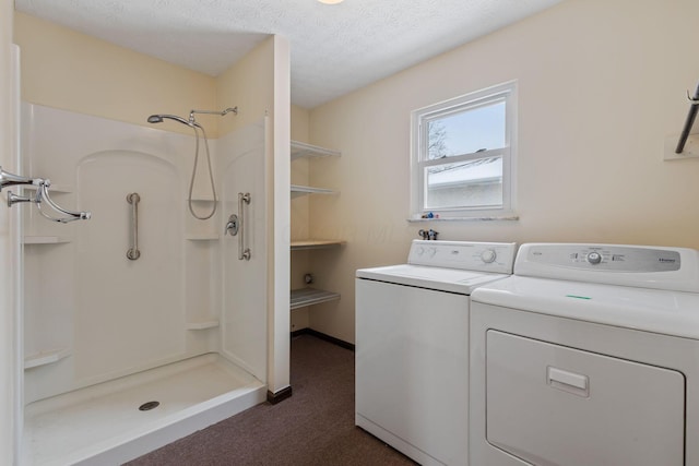 clothes washing area featuring a textured ceiling and separate washer and dryer