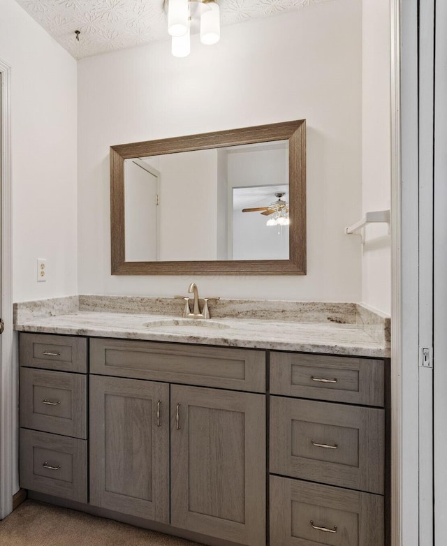 bathroom featuring a textured ceiling and vanity