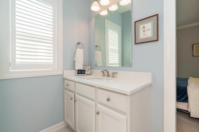 bathroom featuring crown molding and vanity