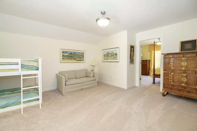 bedroom with light carpet and vaulted ceiling