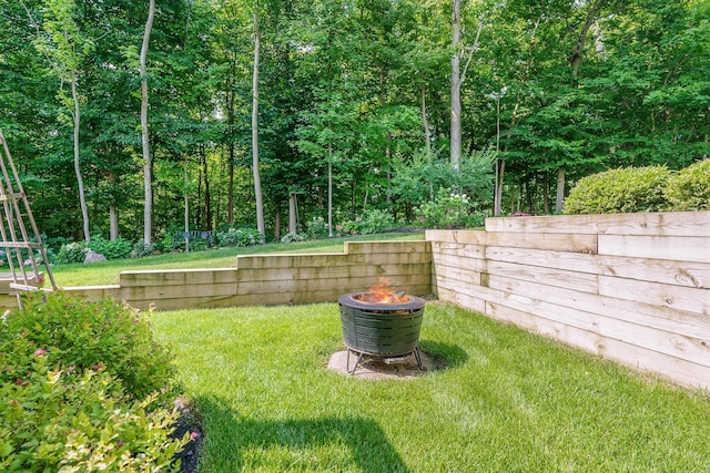 view of yard with a fire pit