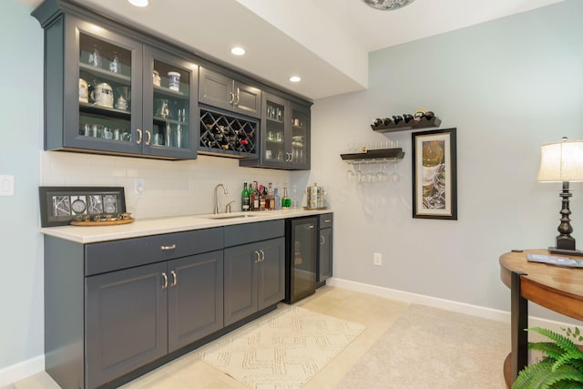 bar with sink, light tile patterned floors, tasteful backsplash, and wine cooler