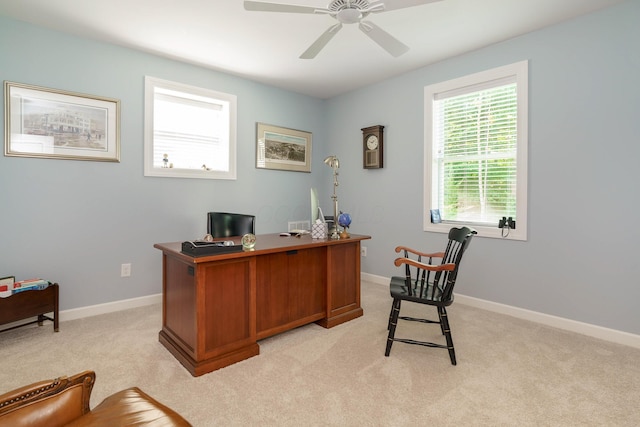 carpeted office space featuring ceiling fan