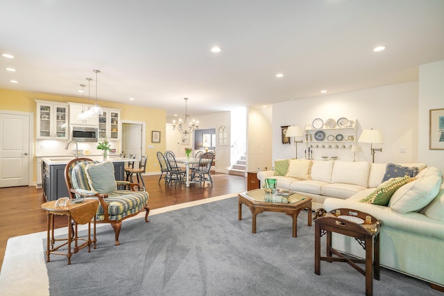 living room with a notable chandelier and dark wood-type flooring