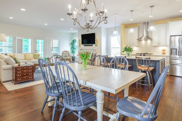 dining room with dark hardwood / wood-style floors and a fireplace