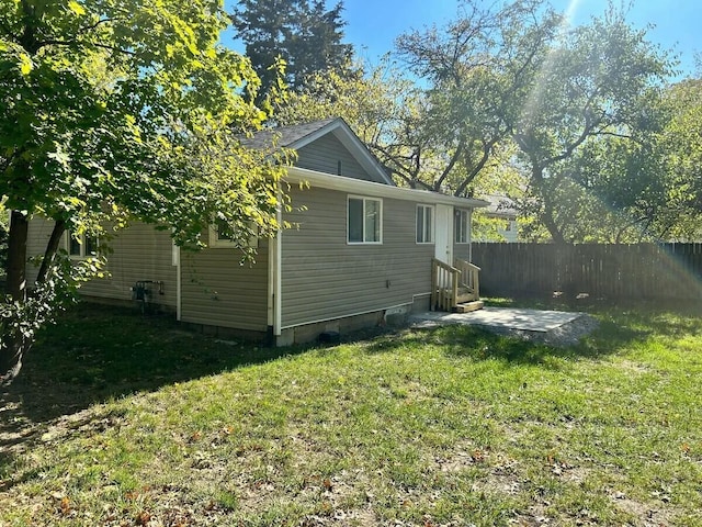 rear view of property featuring a lawn