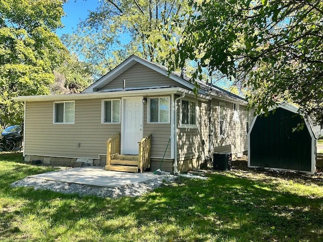 back of house featuring a patio area and a yard