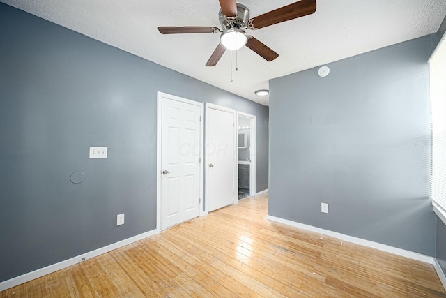 unfurnished bedroom with ceiling fan, light hardwood / wood-style flooring, and a textured ceiling